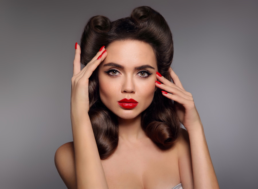 classic eye liner Pin up girl with red lips makeup, manicure nails and retro curls hair