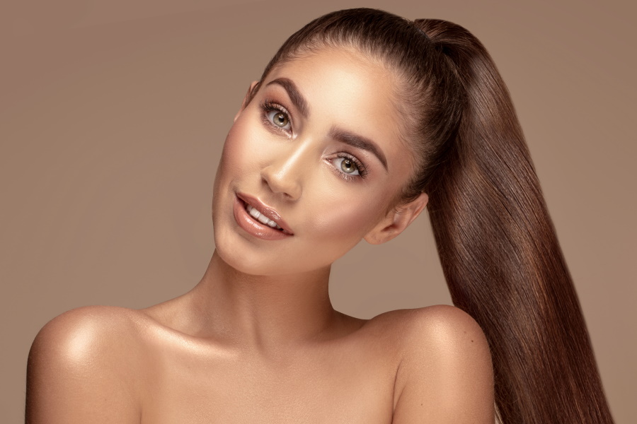 micro Beauty portrait of attractive brunette woman with healthy straight long hair and delicate makeup.