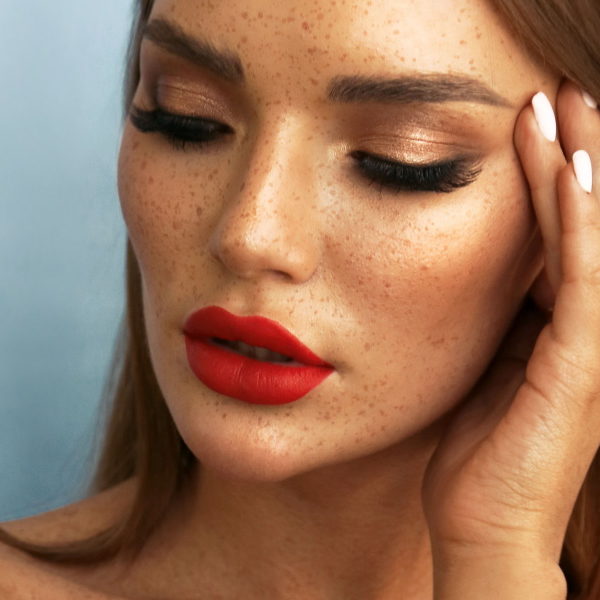 fashion portrait of beautiful woman with dark hair with accessories posing in studio