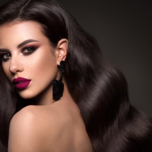 Portrait of a very beautiful girl in the studio. Curly hairstyle