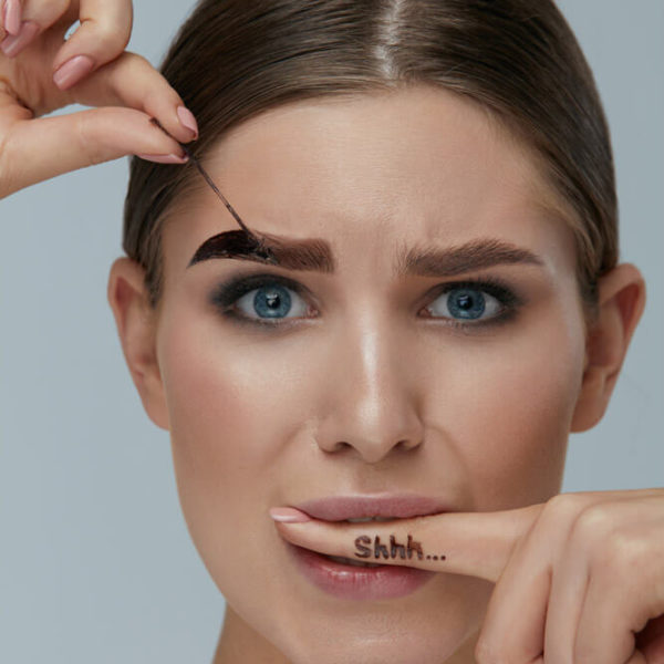 woman adjusting eyebrow