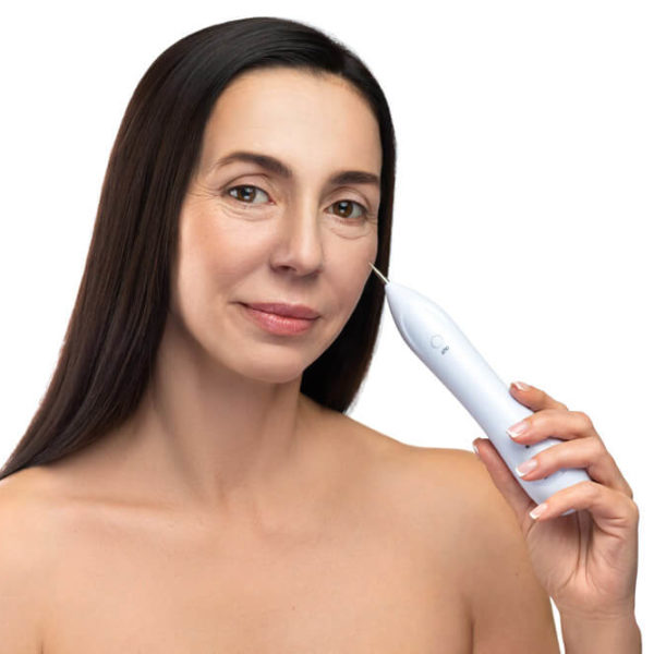 woman using equipment on face