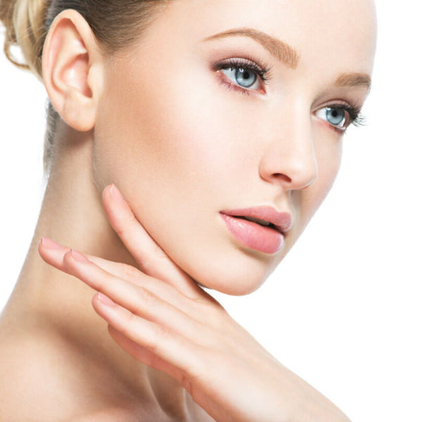 woman looking down and touching face