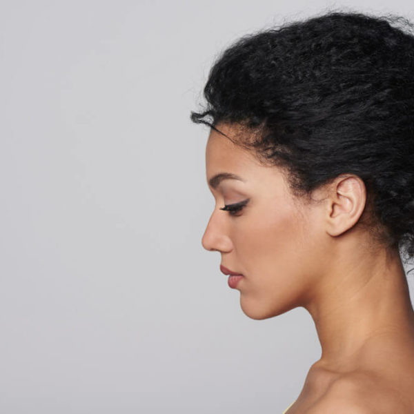 woman on plain background looking down